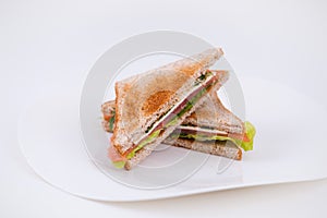 Ham sandwich on a plate on white background