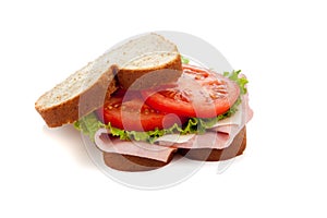 A ham sandwich on wheat on a white background