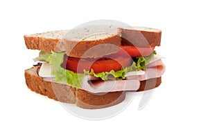 A ham sandwich on wheat on a white background