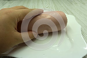 Ham sausage package on white .