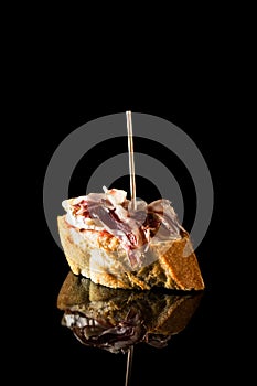 Ham snack isolated on black