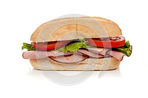 A ham sub sandwich on white
