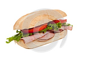 A ham sub sandwich on white