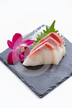 Hamachi Sashimi : Sliced Raw Hamachi Yellowtail Fish Served with Sliced Radish on Stone Plate