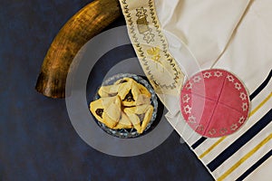 Hamantaschen cookies, carnival mask, noisemakers symbolize a Jewish Purim holiday photo