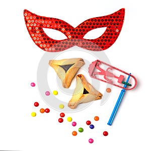 Hamantaschen cookies , grogger and carnival mask on white background