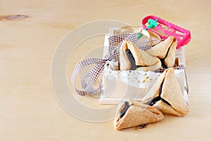 Hamantaschen cookies or hamans ears and Noisemaker for Purim celebration in wooden box