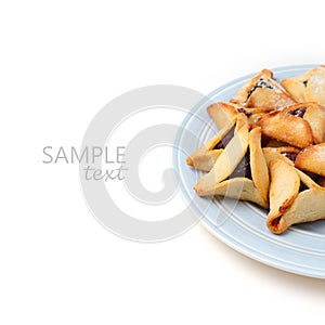 Hamantaschen cookies on plate on white background