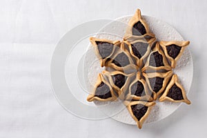 Hamantashen cookies or Aman ears, triangular cookies with poppy seeds