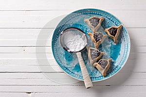 Hamantashen cookies or ears of Haman, triangular cookies with poppy seeds and raisins