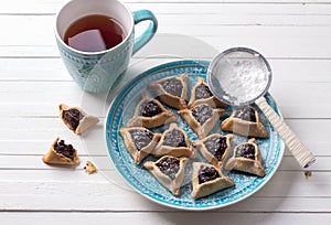 Hamantashen cookies or ears of Haman, triangular cookies with poppy seeds and raisins