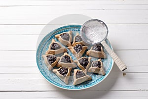 Hamantashen cookies or ears of Haman, triangular cookies with poppy seeds and raisins