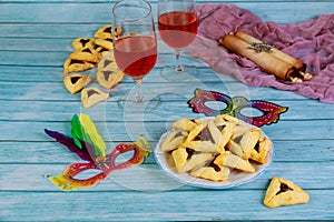 Hamantashen cookies, mask, wine and megillah papyrus roll