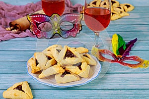Hamantashen cookies with mask, wine and megillah papyrus roll
