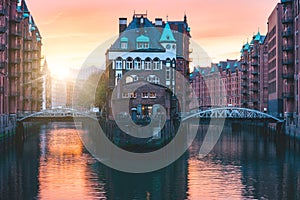 Hamburg city old port, Germany, Europe. Historical famous warehouse district with water castle palace at sunset golden