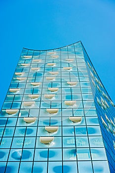 Hamburg, Germany - May 17, 2018: Elbphilharmonie, Close up shot of white oval windows and bright blue glass facade on