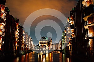 Hamburg, Germany. View of Wandrahmsfleet at dusk illumination light with clouds above. Located in Warehouse District -