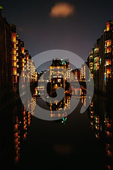 Hamburg, Germany. View of Wandrahmsfleet at dusk illumination light with reflection in the water. Located in Warehouse photo