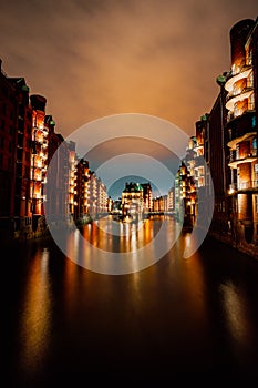 Hamburg, Germany. View of Wandrahmsfleet at dusk illumination light with reflection in the water. Located in Warehouse photo