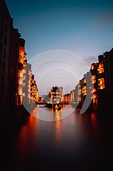 Hamburg, Germany. View of Wandrahmsfleet during sunset with illuminated buildings. Warehouse Landmark District -