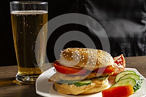 Hamburger with beer on dark background