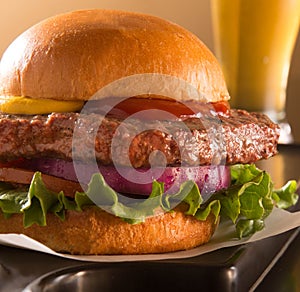 Hamburger on a brioche bun with a beer