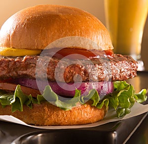Hamburger on a brioche bun with a beer photo