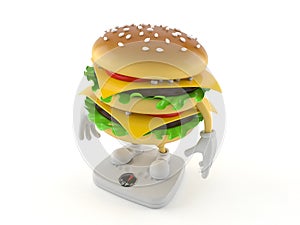 Hamburger character standing on weight scale