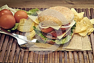 Hamburger with cheese, tomato, onion and lettuce
