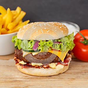 Hamburger Cheeseburger meal fastfood fast food with French Fries on a wooden board square