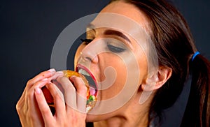 Hamburger eating contest. Woman eat with appetite .