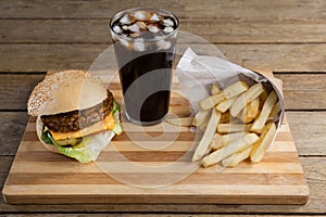 Hamburger, french fries and cold drink on table