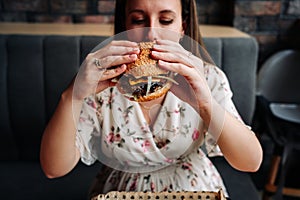 Hamburger girl eat. Pretty Young Happy Woman Eating Tasty Burger. Junk Food Concept.
