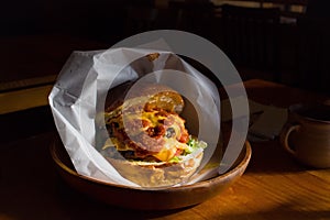 A hamburger glows in the afternoon sunlight.