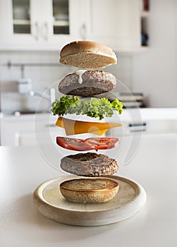 Hamburger ingredients flying in the kitchen