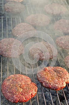 The hamburger meat is fried on the grill