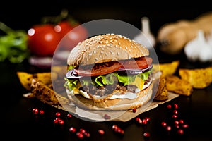 Hamburger with meat patty and cheese. bacon and fresh vegetables