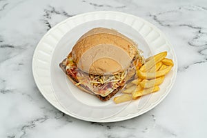 Hamburger with meat, tomato, lettuce and french fries