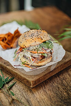 Hamburger with potatoe chips on wooden background