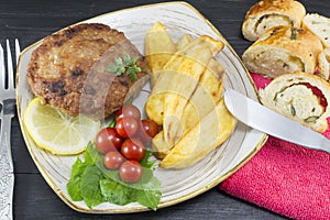 Hamburger steak with potatoes, cherry tomatoes and olive bread o