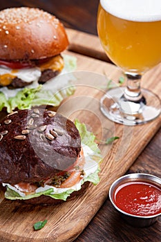 Hamburgers and beer on wooden desk in restaurant