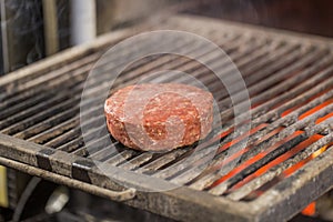 Hamburgers cutlet cooking on grill with flames
