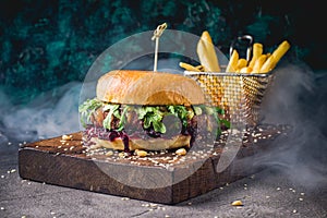 Hamburgers and French fries on the wooden tray