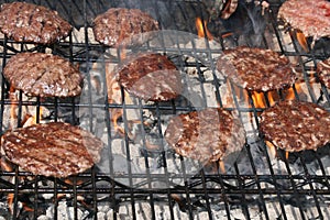 Hamburgers Grilling Over Flames