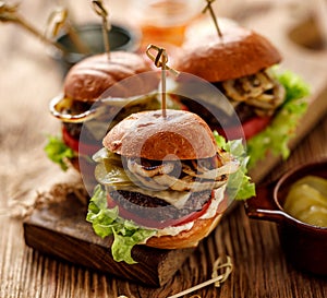 Hamburgers, homemade burgers with grilled buns with addition of addition of beef cutlet, lettuce, tomato,pickled cucumber, grille