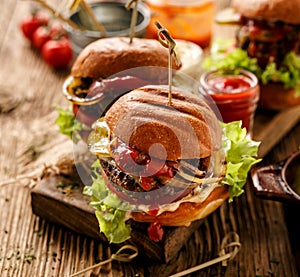 Hamburgers, homemade burgers with grilled buns with addition of addition of beef cutlet, lettuce, tomato,pickled cucumber, grille