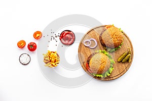 Hamburgers with vegetales and french fries. Top view photo