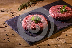 Hamburguer meat on slate dish photo