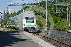 Modern double-Decker train coming to the platform of the railway station, Hameenlinna, Finland