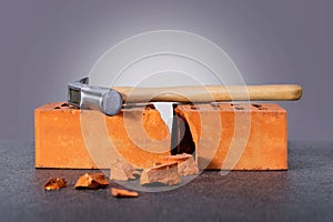 Hammer on a brick-symbol breaking relation